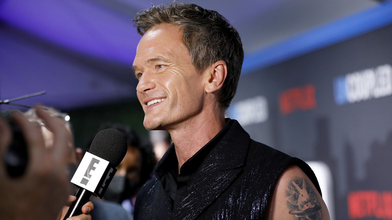 Neil Patrick Harris speaking into the microphone