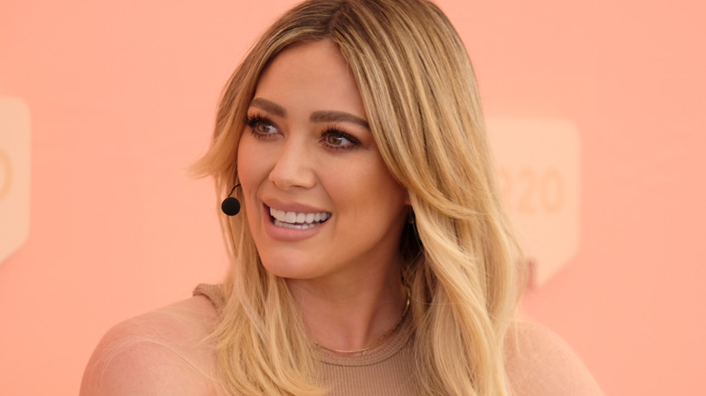 Hilary Duff speaks into a microphone