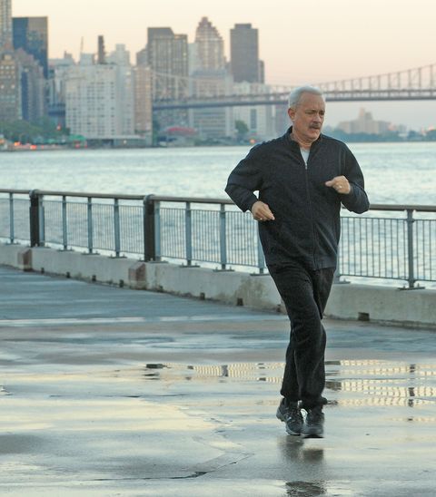 tom hanks runs across the bay in new york in a scene from the movie sully